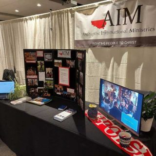 AIM's presentation table at REACH 2022